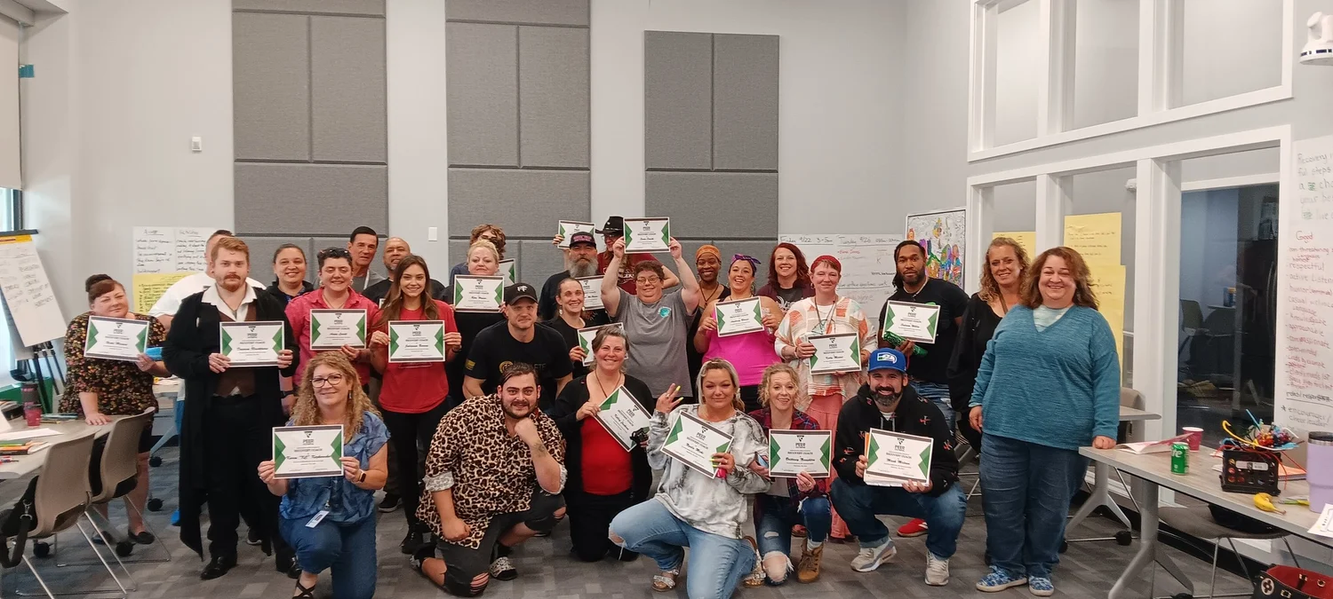Certified Peer Counselor training group holding certificates