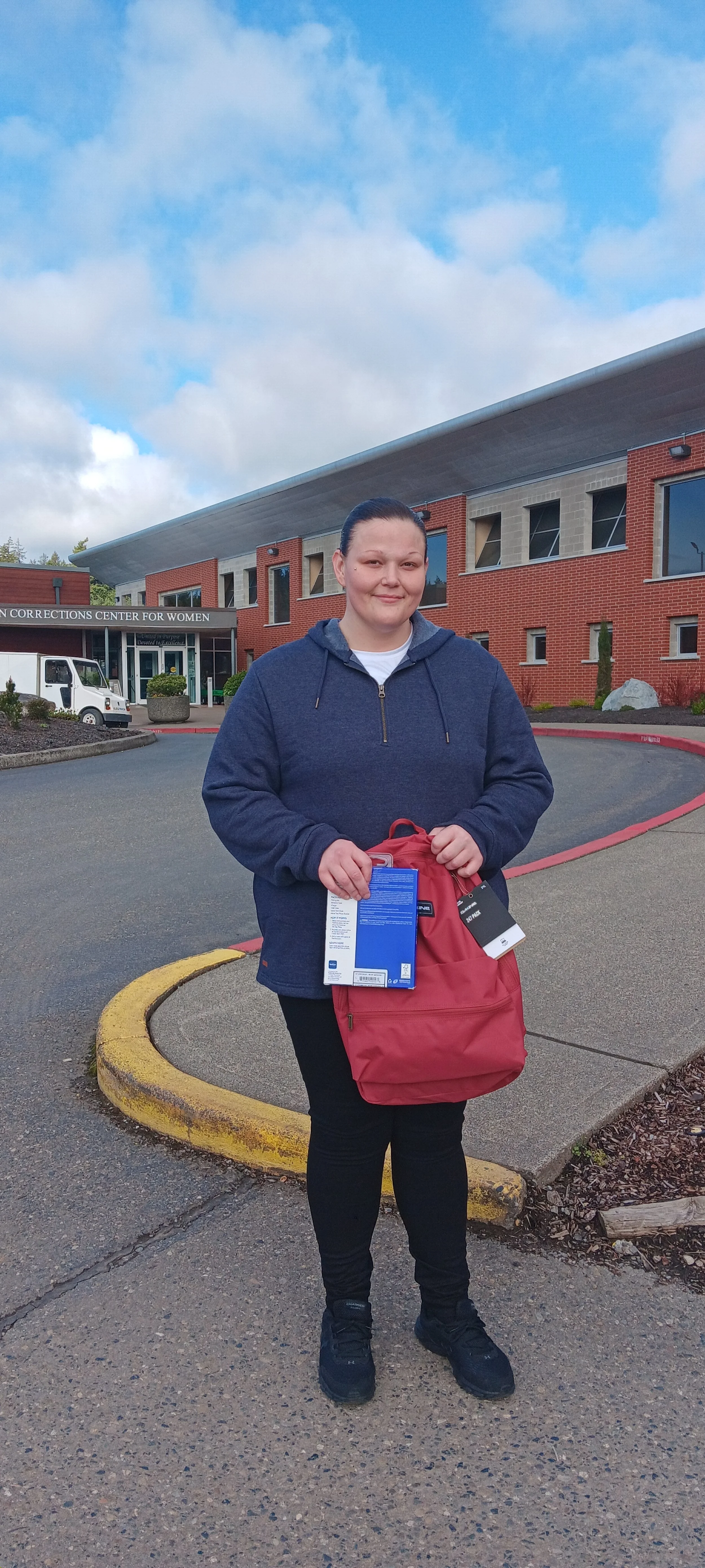 Woman outside Washington Corrections Center for Women with supplies