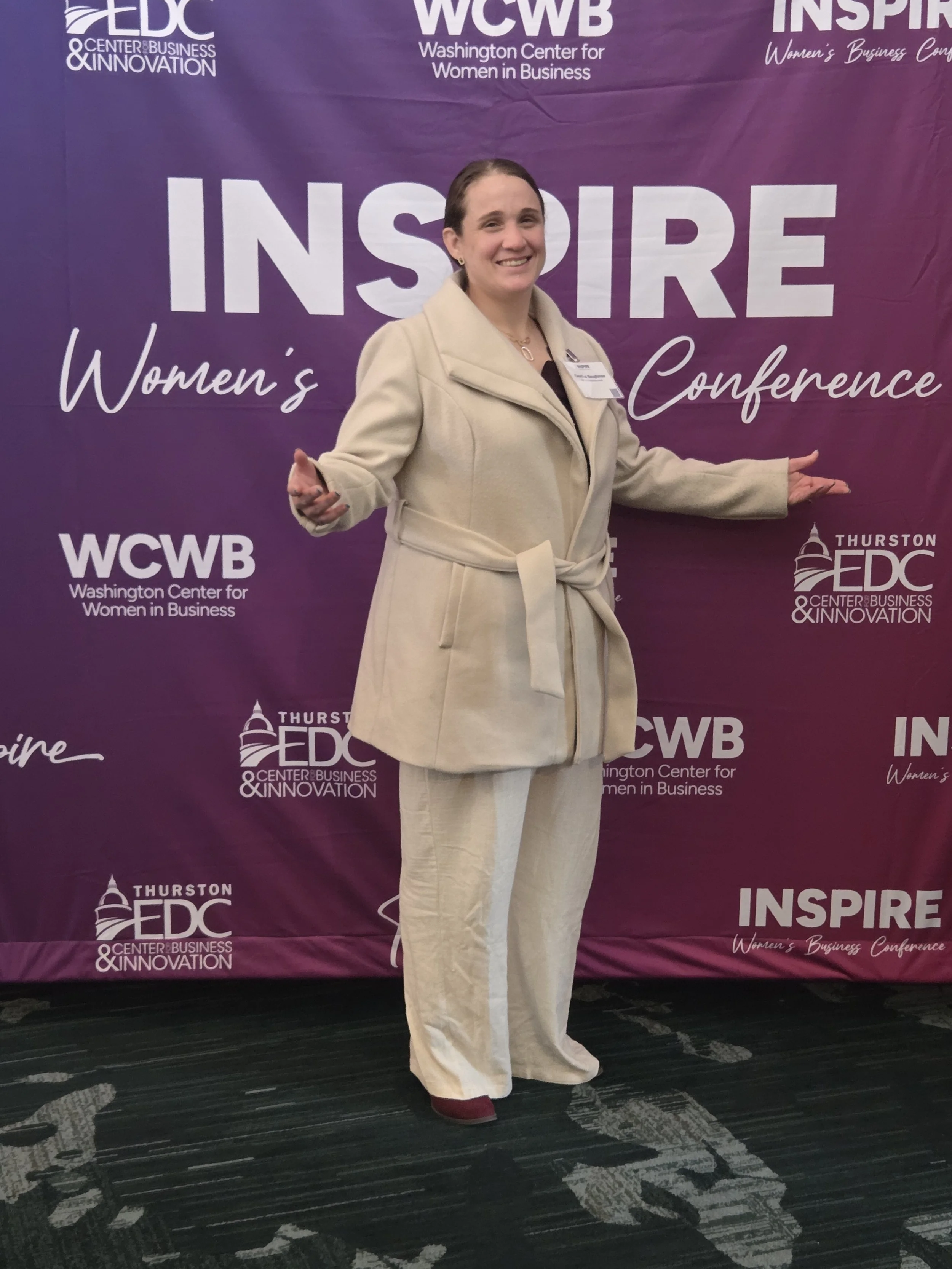 Candice at an Inspire Women conference backdrop